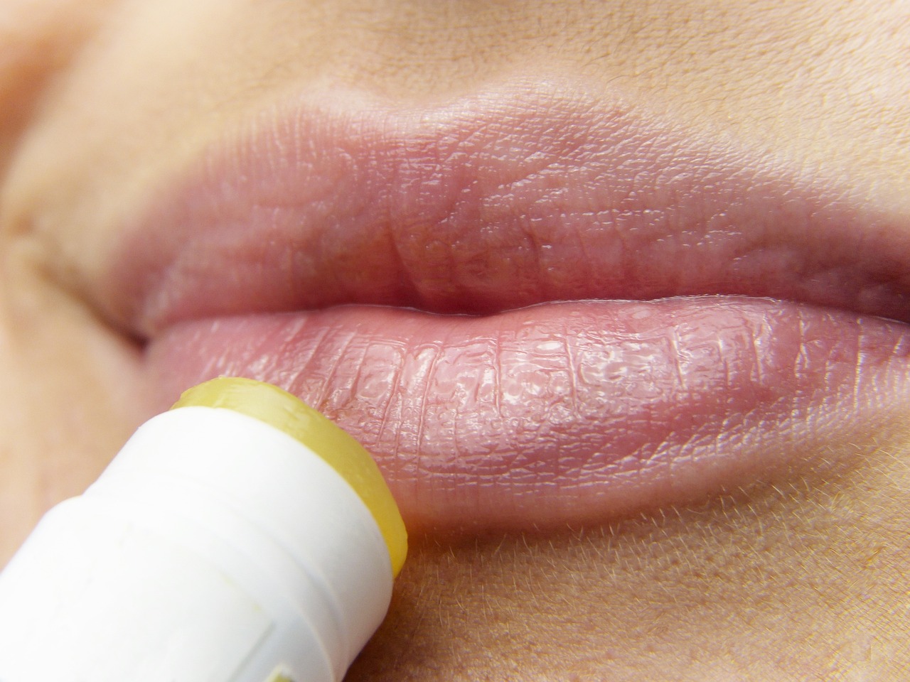 woman applying lipstick - harmful cosmetic ingredients concept