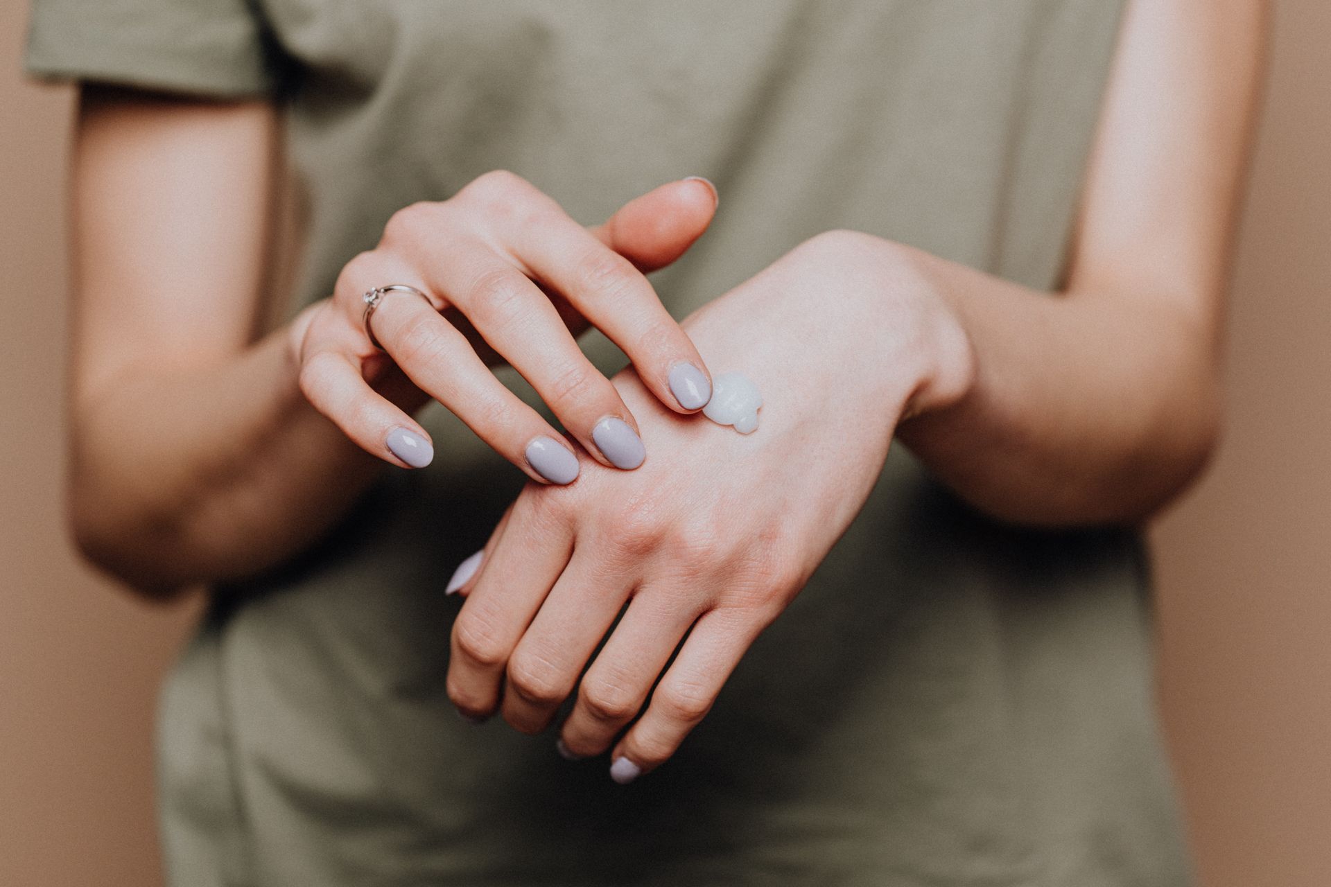 crop-woman-applying-cream-on-hands